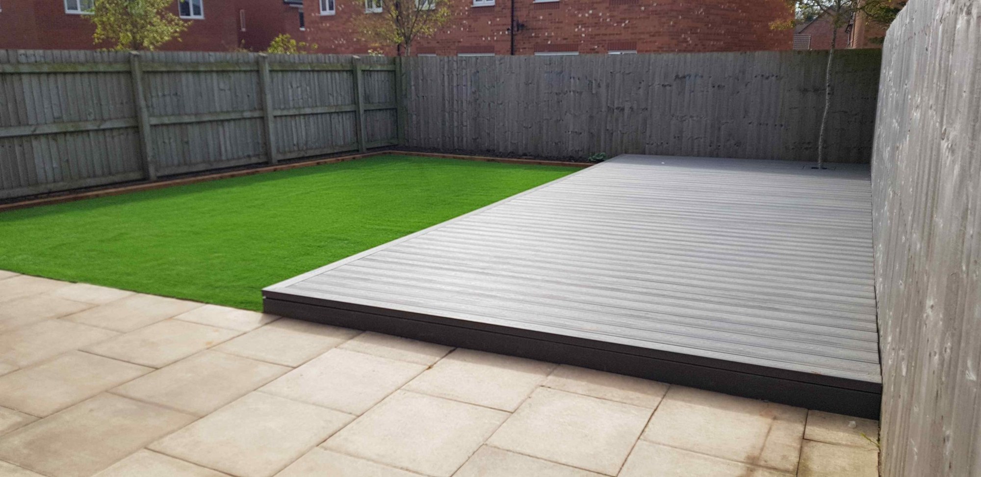 Paving, lawn and grey decking in an Inspired Gardens project